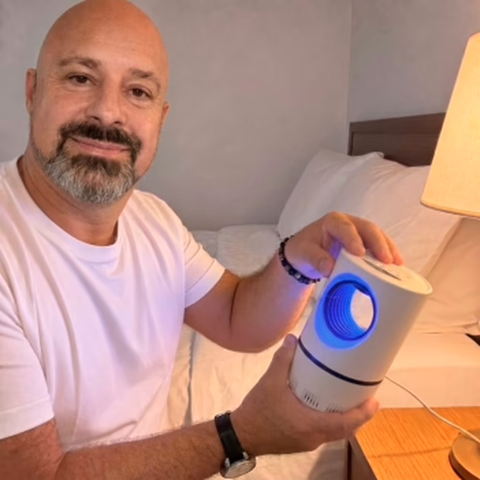 Owner showing the ZapiTrap lamp on his bedside table
